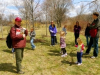 Maggi Brown, interpretive ranger, brings families up North Trail at Alewife Reservation